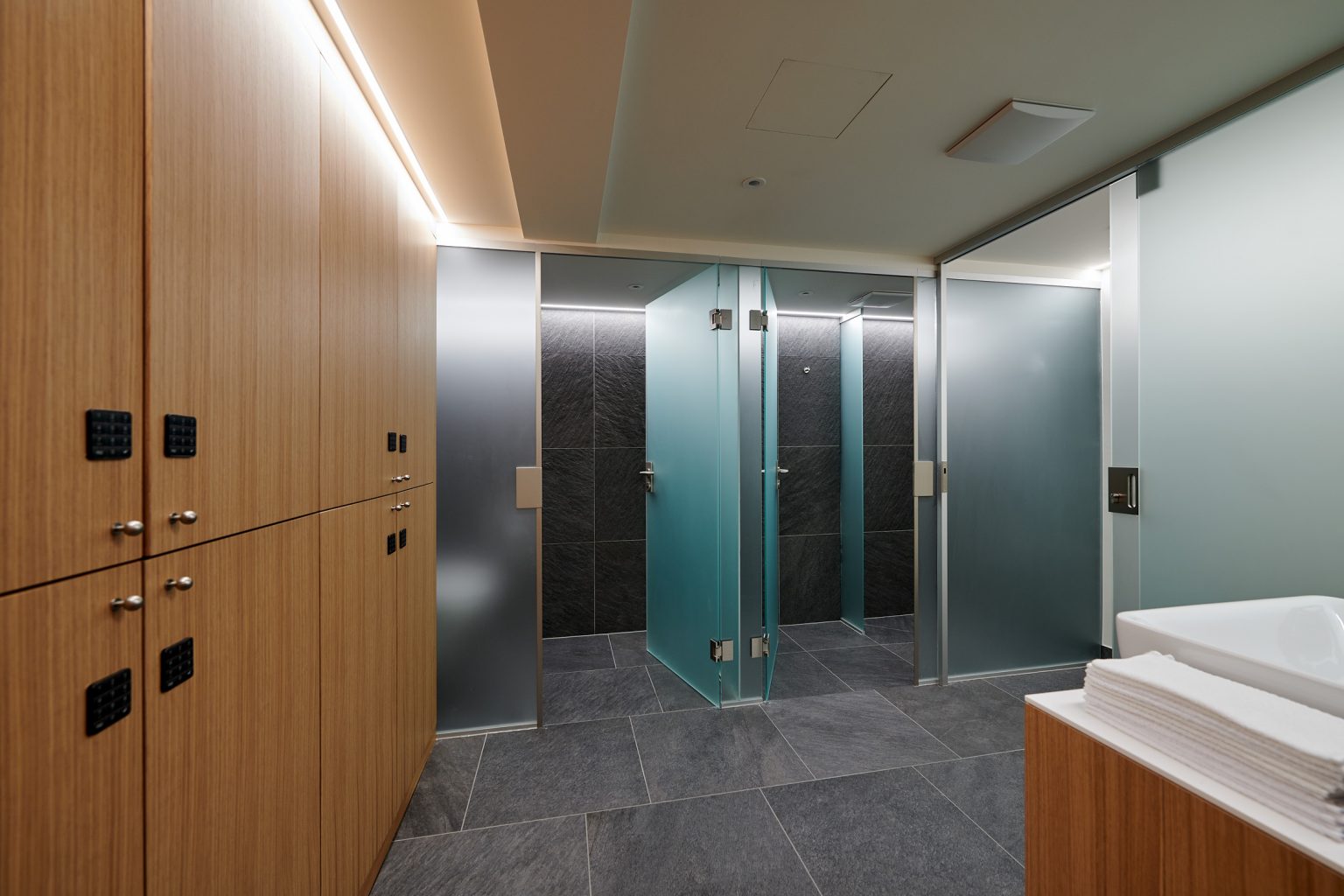 moderne Dusche mit Glaswänden und dunklen Fliesen Hotel Roggal Lech am Arlberg